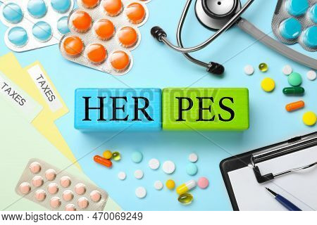 Word Herpes Made Of Colorful Cubes, Different Pills And Stethoscope On Light Blue Background, Flat L