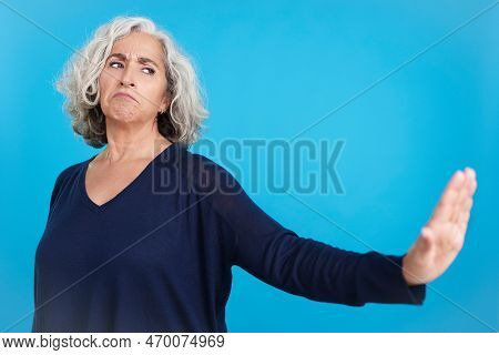 Mature Woman Gesturing That She Wants To Know Nothing