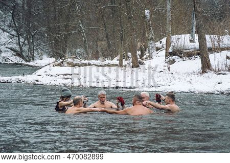 Vilnius, Lithuania - February 03 2023: Group Of People In Circle Ice Bathing Together In The Cold Wa