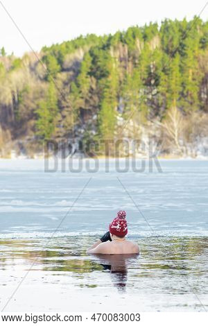 Man Or Boy With A Warm Hat And Gloves Ice Bathing In The Cold Water Of A Lake. Wim Hof Method, Cold 