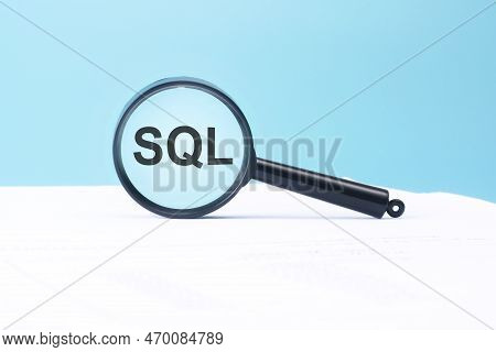 Look At The Text Sql Through A Magnifying Glass On A Blue And White Background