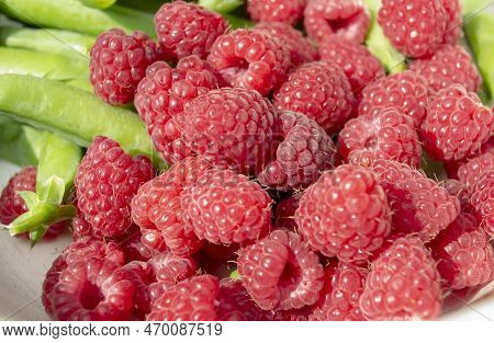Raspberries And Green Peas. Red Raspberries With Green Peas. Raspberries And Green Peas In Pods. Hea