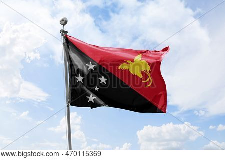 Papau New Guinea Waving Flag Against Cloudy Sky Background