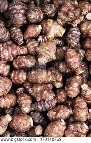 Background Of Fresh Jerusalem Artichokes Or Sunroot, Sunchoke In Market Or Havest.