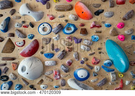 Close Up Of Multiple Climbing Wall Holds, Grips And Footholds Of Various Colours, Shapes And Sizes O