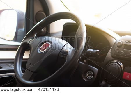 Car Steering Wheel, Interior View Of Modern Car And Black Dashboard With Sun Light.