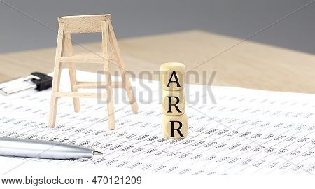 Wooden Cubes With The Word Arr Stand On Financial Background, Business Concept.