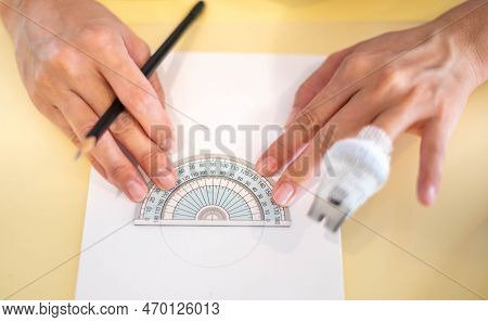 Female Hand Using A Measure Circle Ruler With A Wood Pencil Preparing To Draw And Sketch On The Empt