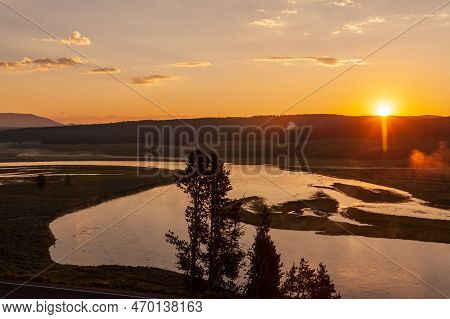 Early Morning In Hayden Valley, Yellowstone National Park, As The Sun Is Just Peaking Over The Horiz