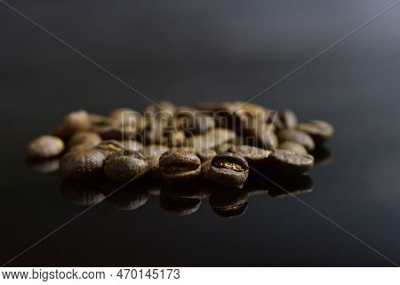 Peaberry Coffee Beans And Coffee Beans On Dark Background.  Soft Selected Focus