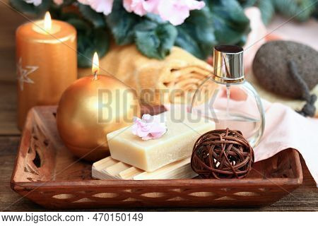Spa Concept With Candles In Gold And Pink. Handmade Olive Soap, Facecloth, Towel, Candles And Pink C