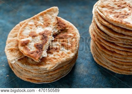 Flatbread Lavash, Chapati, Naan, Heap Of Tortilla On A Blue Background Homemade Flatbread Stacked.