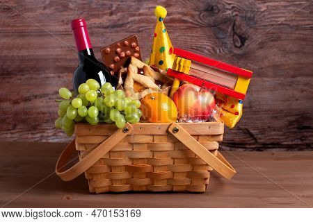 Purim Gift Basket With Foods, Wine, Gragger And Carnival Costume Accessories