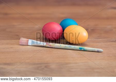 Group Of Colored Easter Eggs Together With Single Paint Brush. Handmade Pastel Easter Egg For Easter