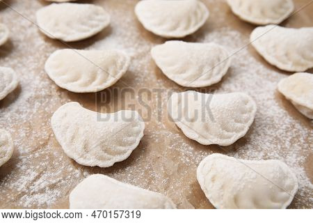 Raw Dumplings (varenyky) With Tasty Filling And Flour On Parchment Paper, Closeup View
