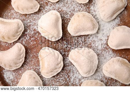 Raw Dumplings (varenyky) With Tasty Filling And Flour On Wooden Table, Flat Lay