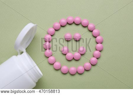 Happy Emoticon Made Of Antidepressants And Medical Bottle On Light Green Background, Flat Lay