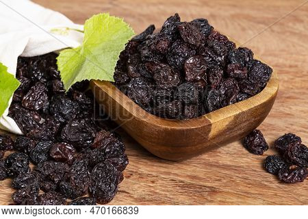 Healthy Food - Nuts Dehydrated Grapes; Photo On Wooden Background