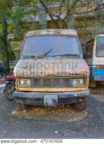 Stock Photo Of Abandoned Broken, Damaged White Color Vans, Motorcycle Left In The Scrap Yard For Rec