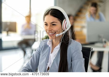 Portrait Of Dedicated Female Operator Agent Working At It Support Sector