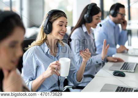 Portrait Of Dedicated Female Operator Agent Working At It Support Sector