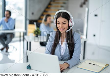 Portrait Of Dedicated Female Operator Agent Working At It Support Sector