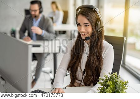 Portrait Of Dedicated Female Operator Agent Working At It Support Sector