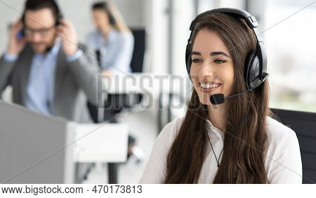 Portrait Of Dedicated Female Operator Agent Working At It Support Sector