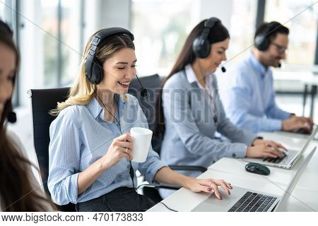 Portrait Of Dedicated Female Operator Agent Working At It Support Sector