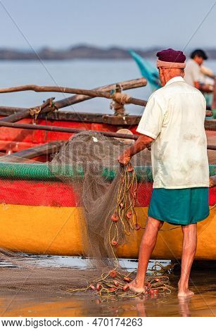 Morjim, North Goa, India , 29 March 2016: Local Fishermen. Fisherman Cleans The Net On The Ocean. Fi