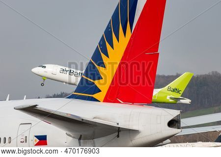 Zurich, Switzerland, January 20,2023 Air Baltic Bombardier Cs-300 Or A220 Plane Is Taking Off Behind