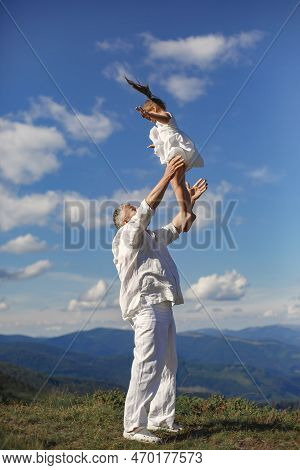 Father Playing With Ittle Daughter In A Mountains