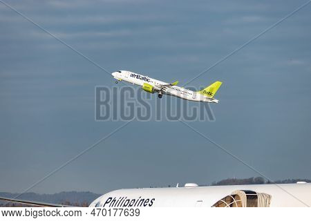 Zurich, Switzerland, January 20,2023 Air Baltic Bombardier Cs-300 Or A220 Is Taking Off Behind A Phi