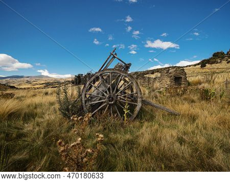 Remains Of Old Historical Traditional Wooden Wheel Cart, Agriculture Farming Tool In High Grass At B