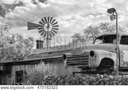 Loxton, South Africa - Sep 2, 2022: A Street Scene, With A Corrugated Iron Building, Windmill And An