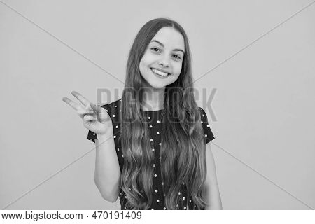 Cheaky Teen Girl Giving Victory Sign. Happy Teenager Child Smiling With V-sign, Positive Gesture, St