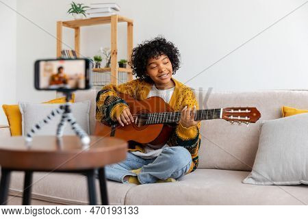 Blogger Guitarist. African American Girl Blogger Playing Guitar Talking To Webcam Recording Vlog. So