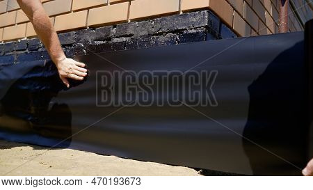Waterproofing Of The Base Of The Building. Front On External Insulation Works. New Basement Foundati