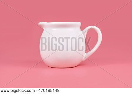 Single White Creamer Pitcher On Pink Background