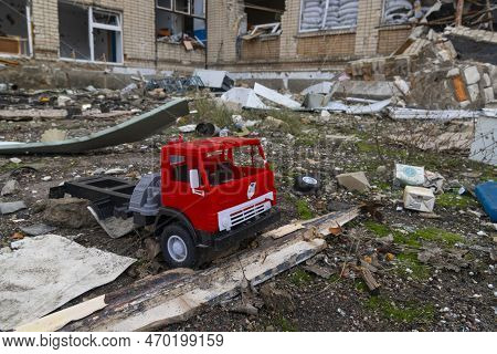 Children\'s Toy On The Background Of The Destroyed School. War In Ukraine. Russian Invasion Of Ukrai