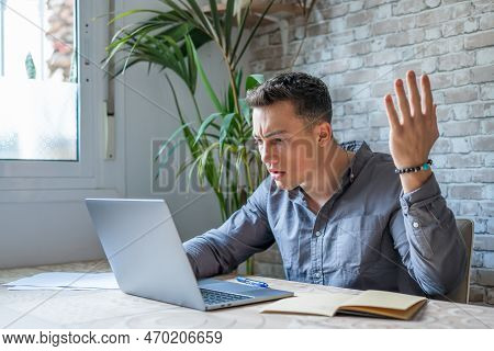 Unhappy Young Caucasian Male Worker In Glasses Look At Laptop Screen Shocked By Gadget Breakdown Or 