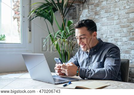 Confident Man Sitting At Desk Taking Break In Work With Electronic Documents On Laptop To Make Answe