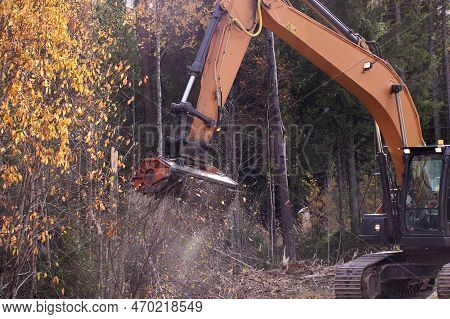 Mulching Head On An Excavator Clearing Side Of Forest Road.