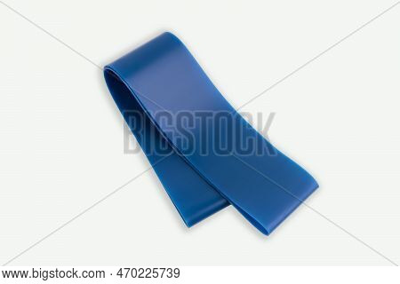 Fitness Elastic Band. Woman Showing A Blue Rubber Band. Sport And Healthy Active Lifestyle Concept. 