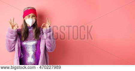 Covid-19, Pandemic And Fashion Concept. Awesome Asian Grandmother Wearing Stylish Disco Dress And Re