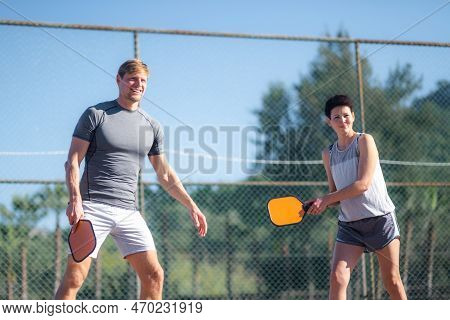 Couple Playing Pickleball Game, Hitting Pickleball Yellow Ball With Paddle, Outdoor Sport Leisure Ac