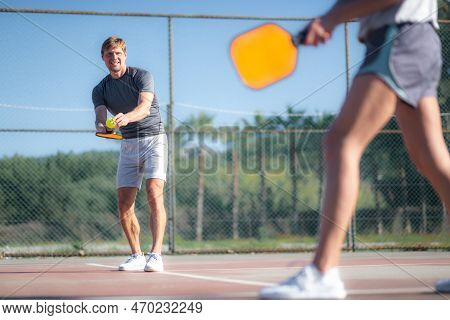 Couple Playing Pickleball Game, Hitting Pickleball Yellow Ball With Paddle, Outdoor Sport Leisure Ac