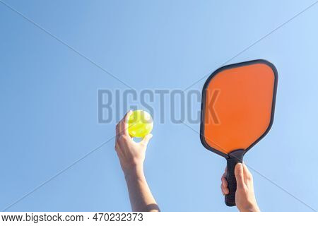 Pickleball Game, Hands Over Blue Sky Hitting Pickleball Yellow Ball With Paddle, Outdoor Sport Leisu