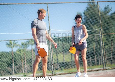 Couple Playing Pickleball Game, Hitting Pickleball Yellow Ball With Paddle, Outdoor Sport Leisure Ac