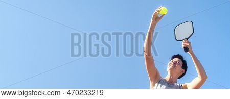 Pickleball Banner Over Blue Sky, Woman Playing Pickleball Game, Hitting Pickleball Yellow Ball With 